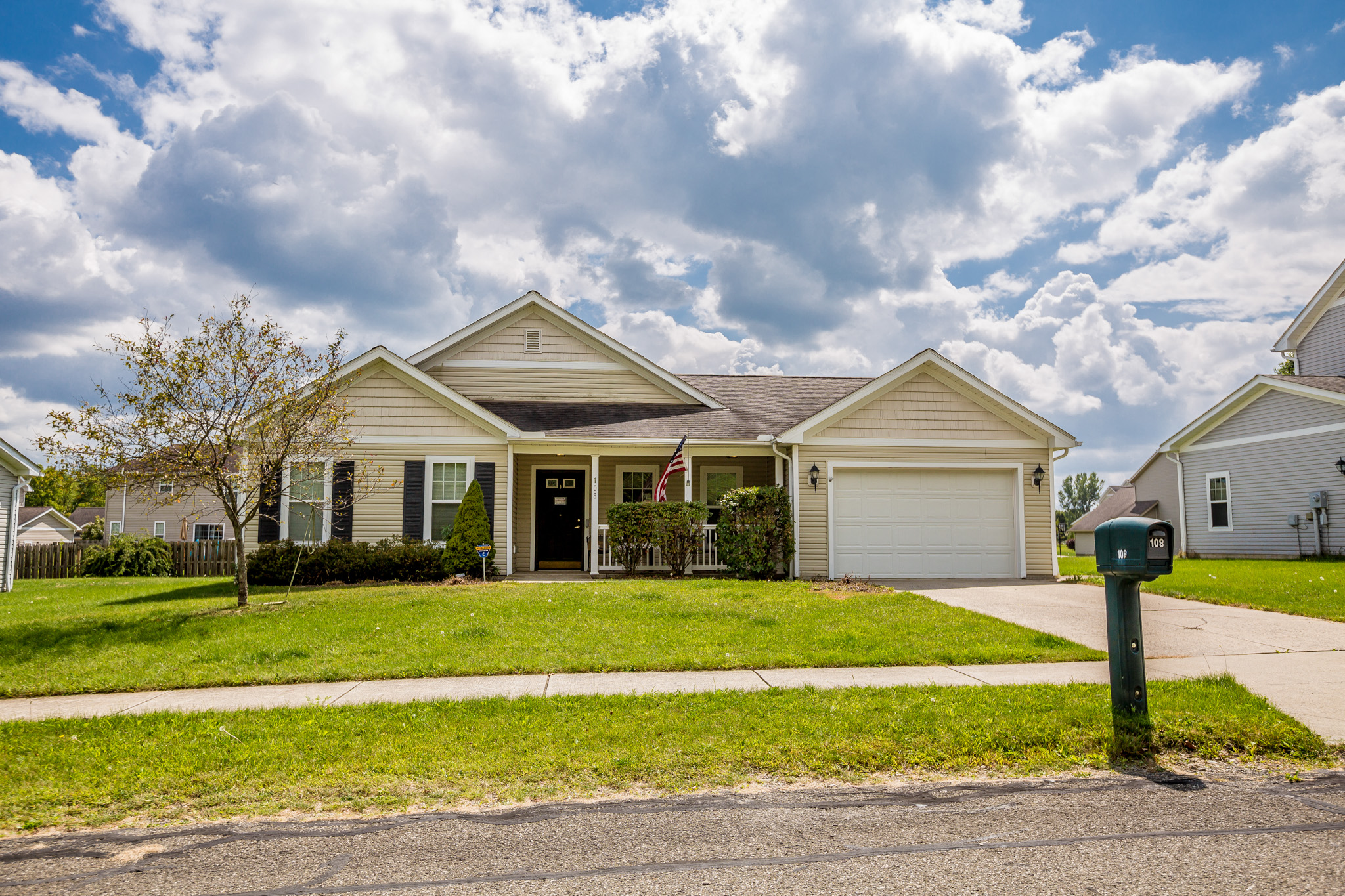 a house with a lawn and a parking meter in front of it